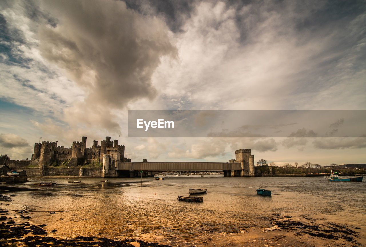 Conwy castle by river against sky