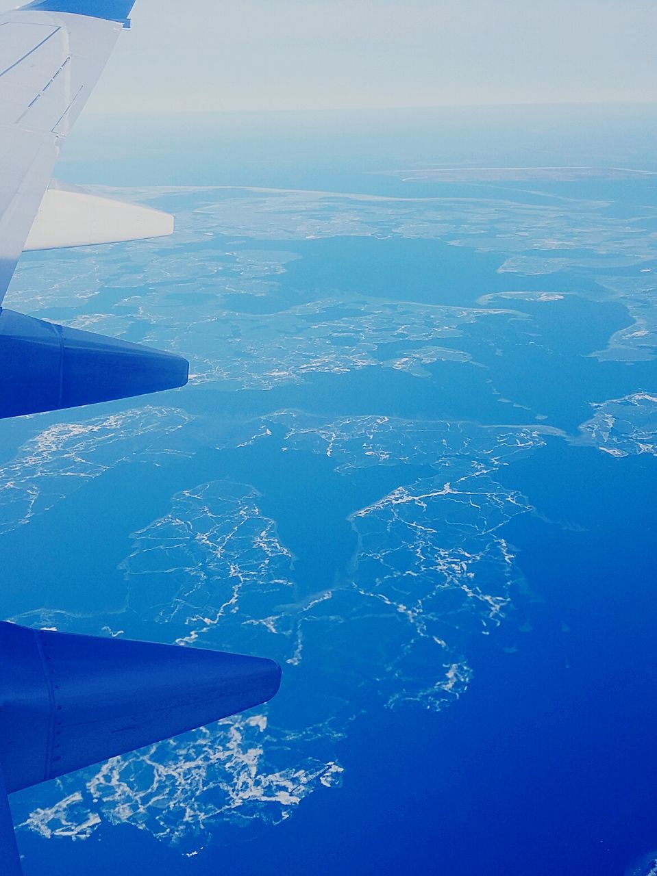 AERIAL VIEW OF AIRCRAFT WING OVER SEA