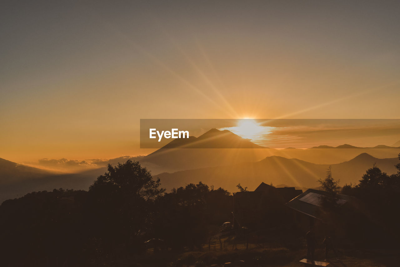 Scenic view of silhouette mountains against sky during sunset