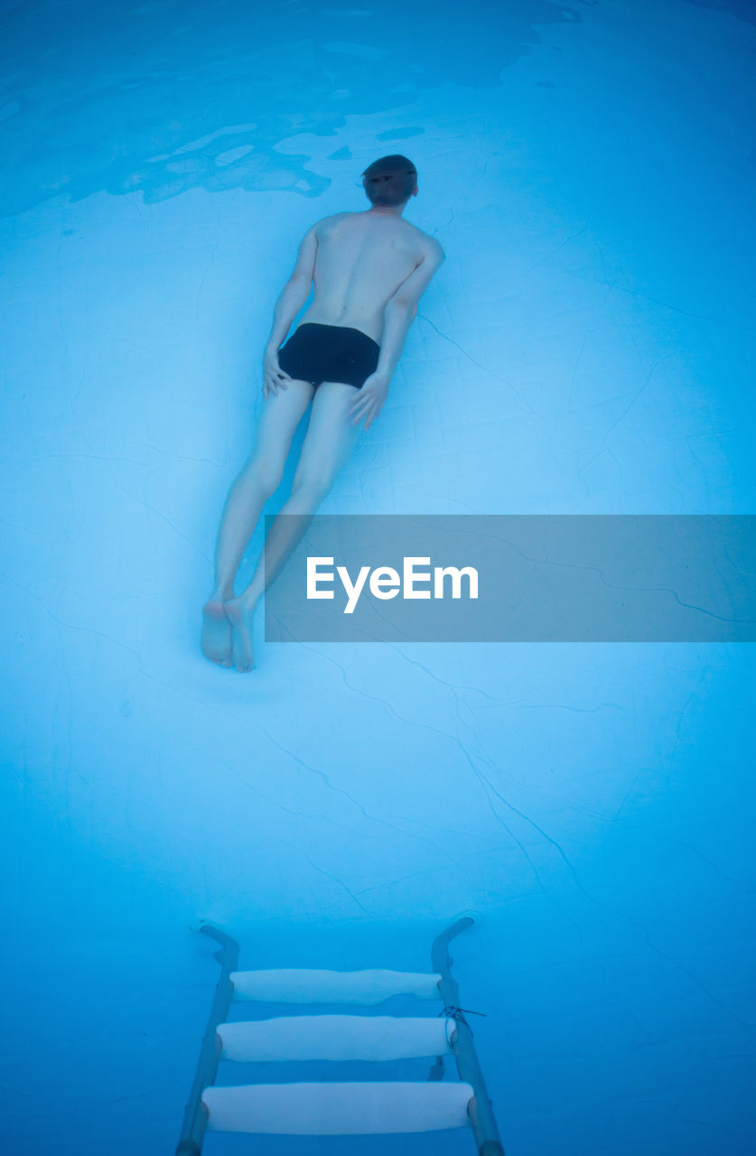 High angle view of man swimming in pool