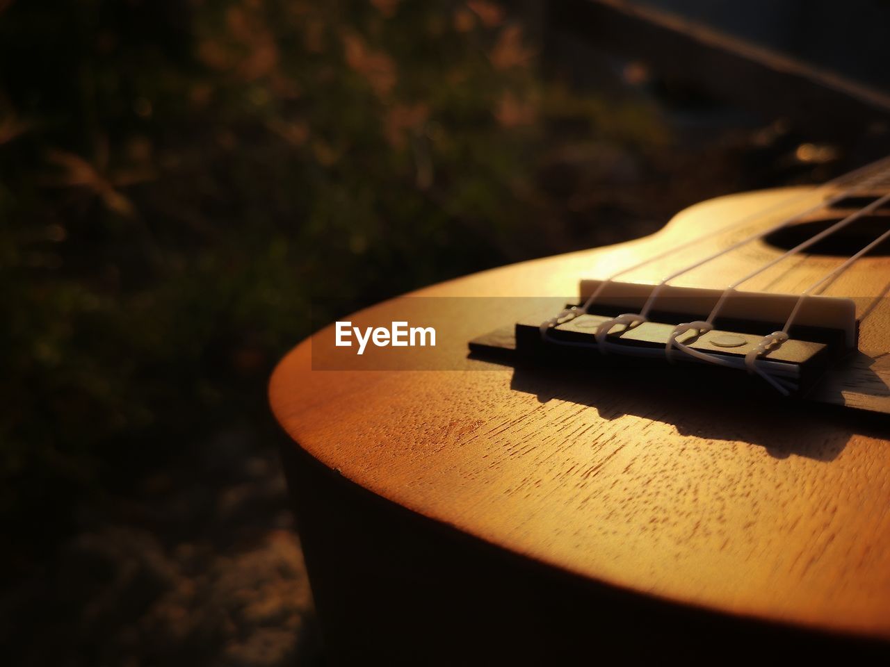 CLOSE-UP OF GUITAR AND TABLE