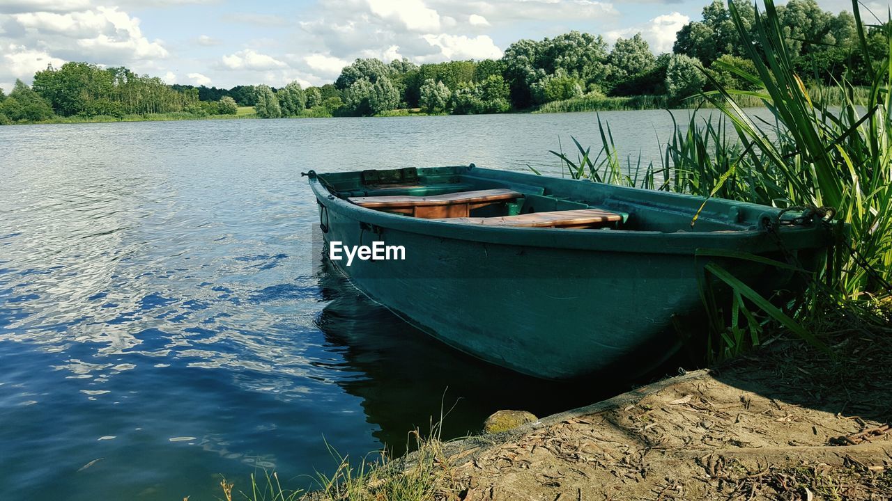 Boat in lake against sky