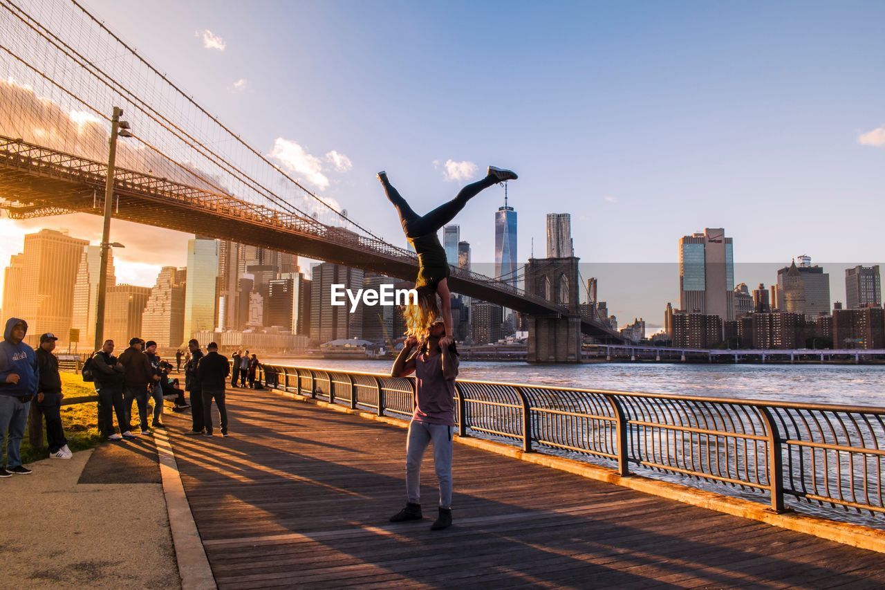 PEOPLE ON BRIDGE IN CITY