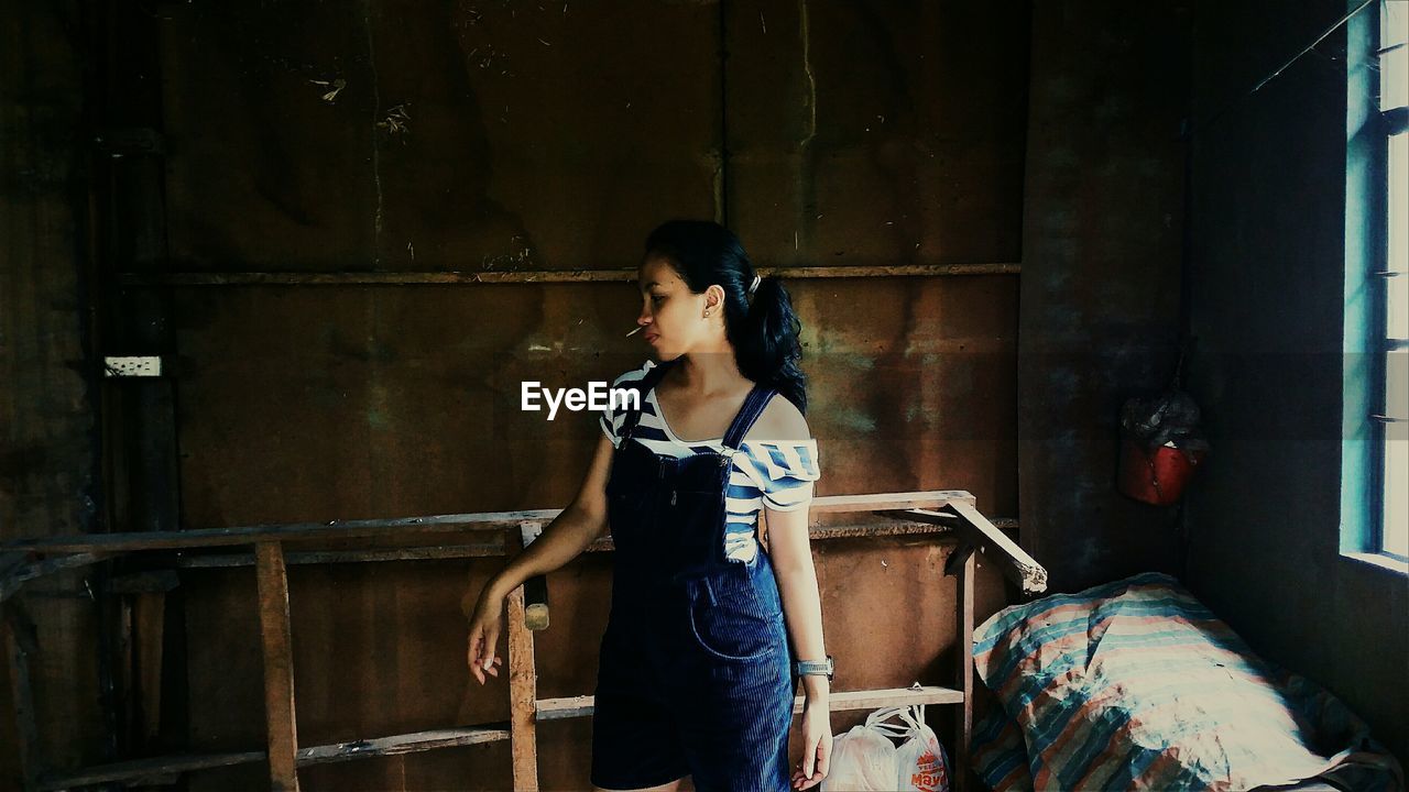 Woman standing in abandoned building