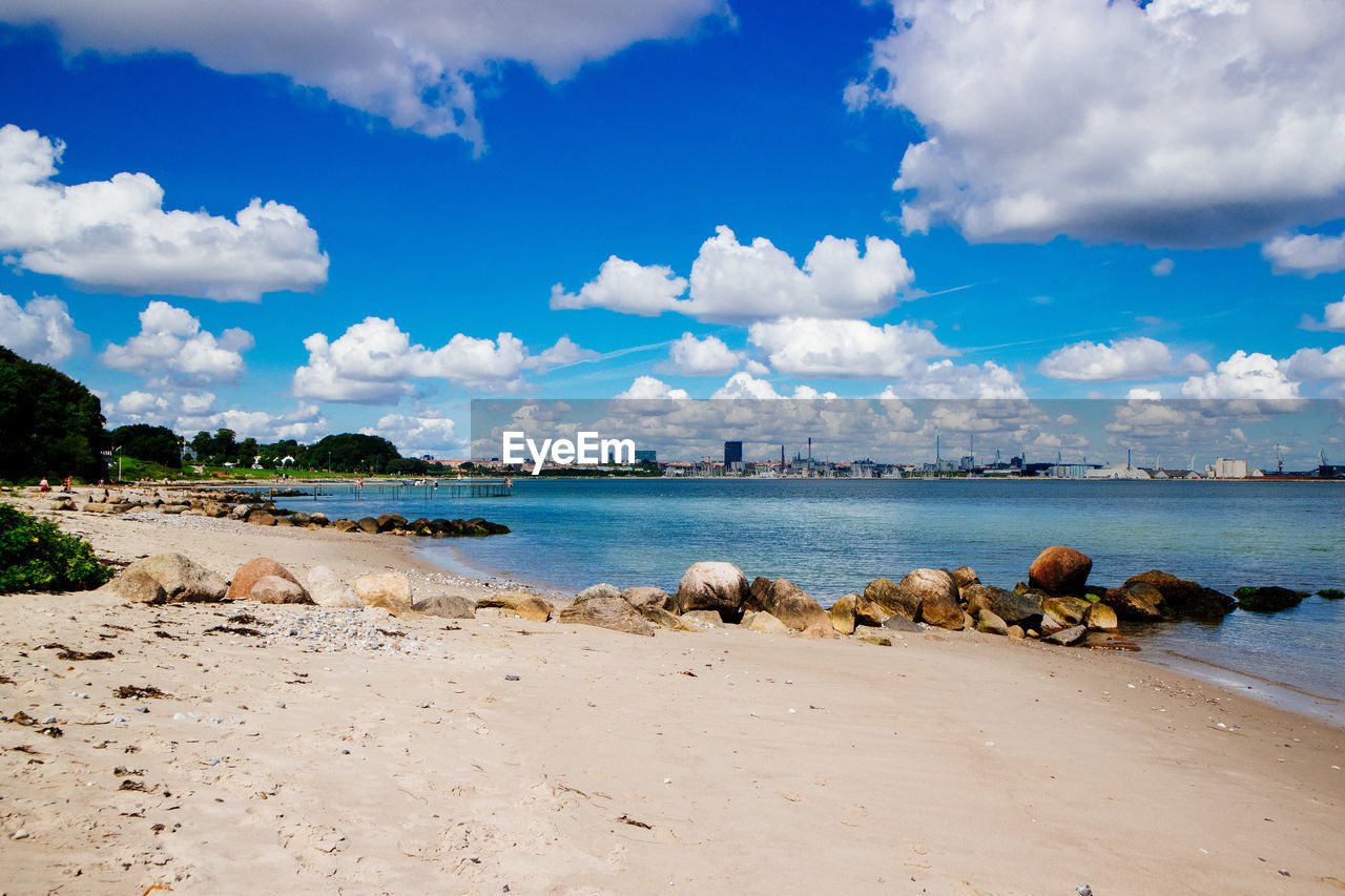 Scenic view of beach against blue sky