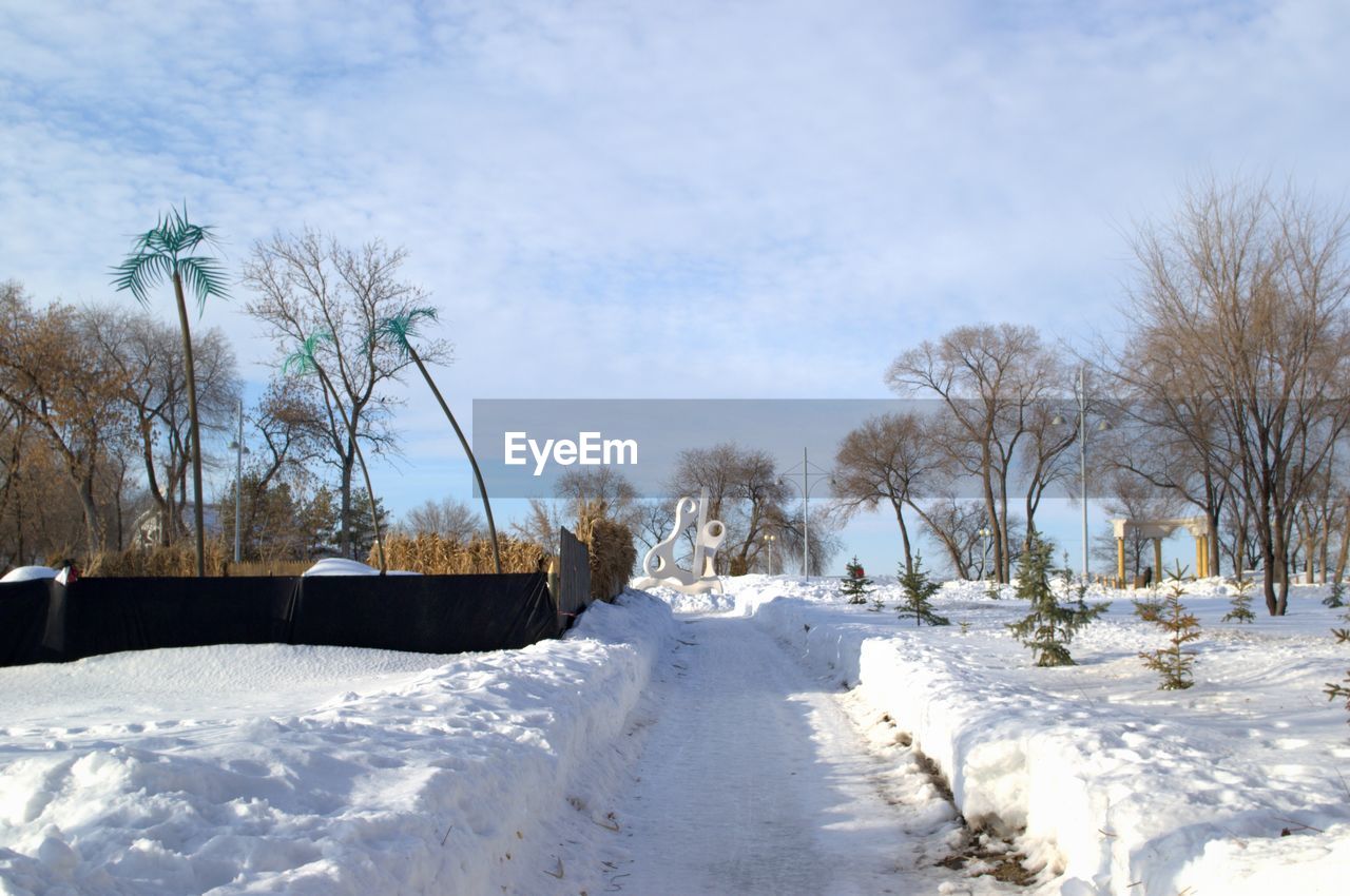 SNOW COVERED FIELD AGAINST SKY