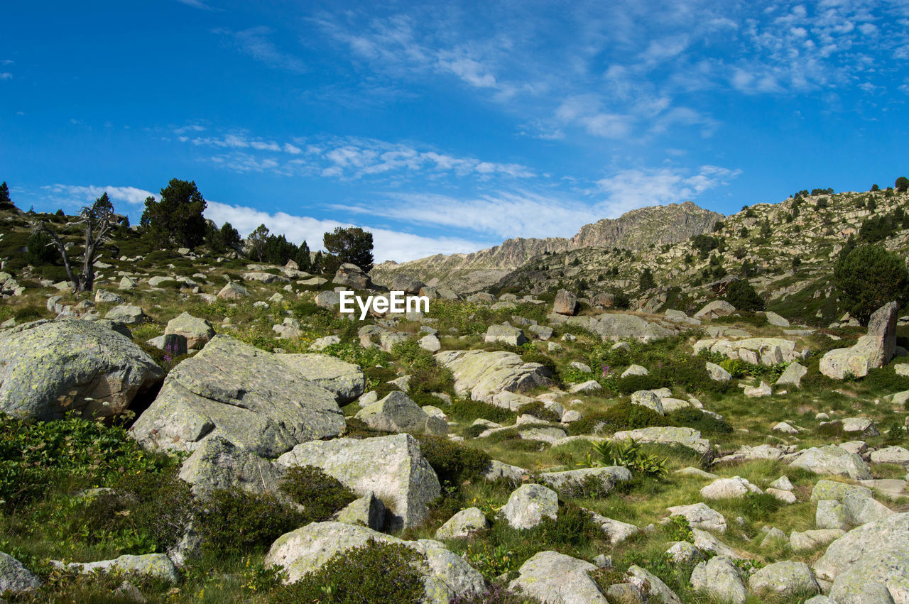 Rock formations on landscape against sky