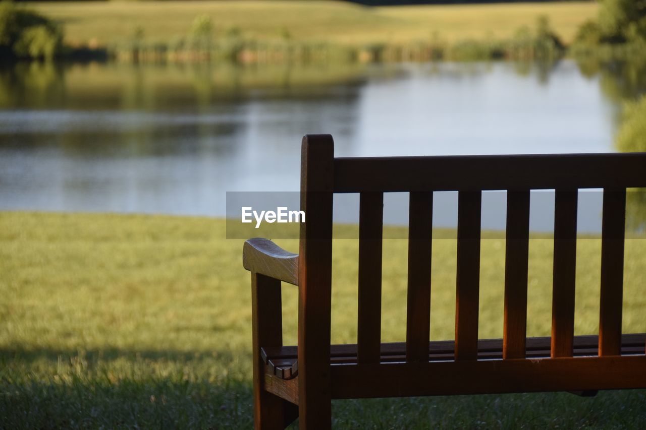 CHAIR ON FIELD BY LAKE