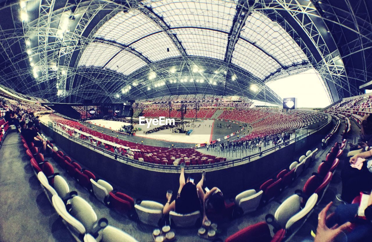 PANORAMIC VIEW OF CROWD IN ILLUMINATED UNDERGROUND