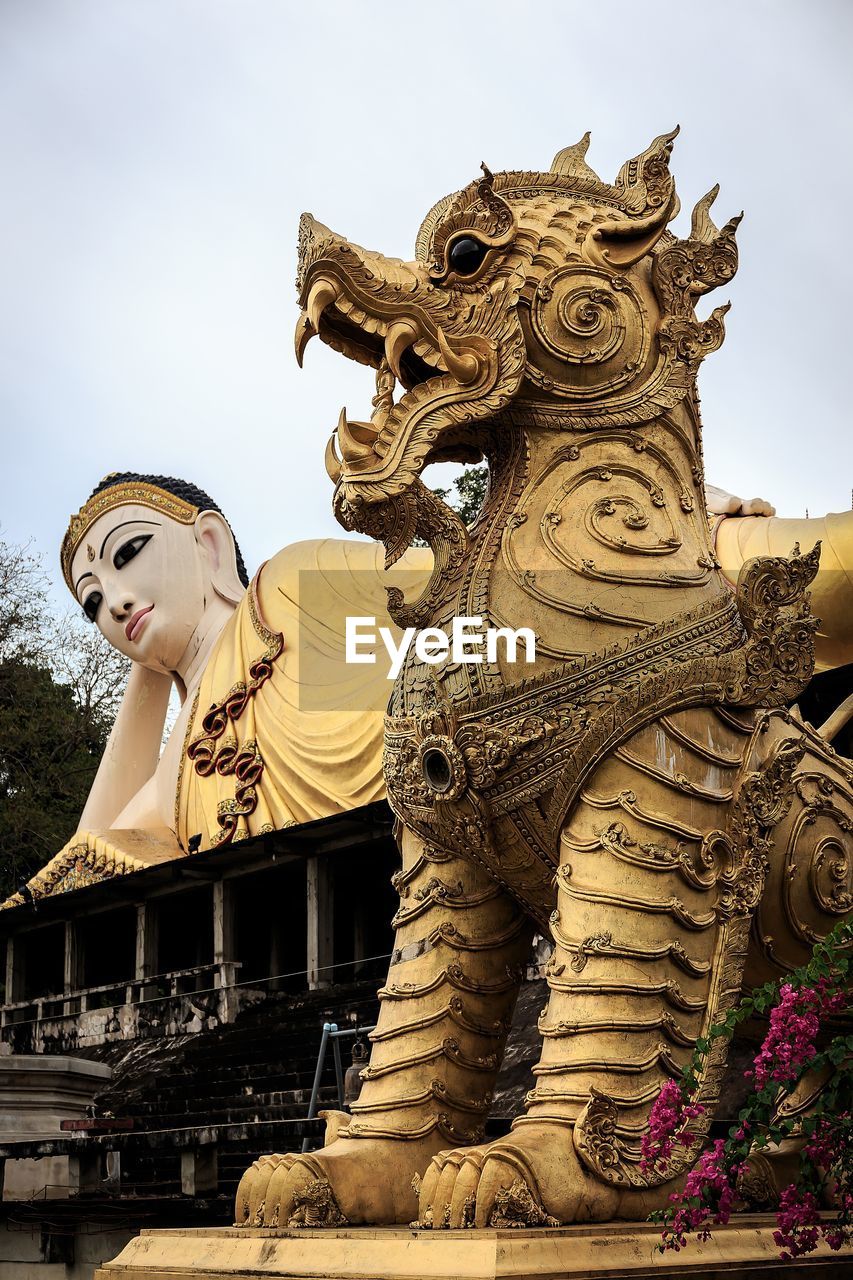 Low angle view of statues against clear sky