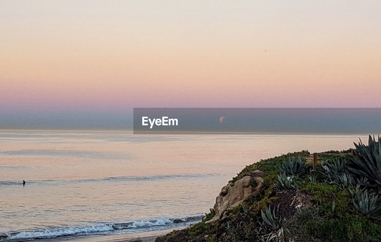 SCENIC VIEW OF SEA AGAINST SKY AT SUNSET