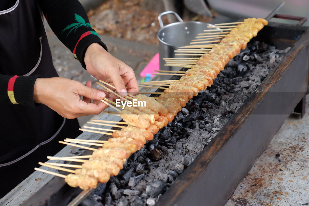 Man preparing food on barbecue grill