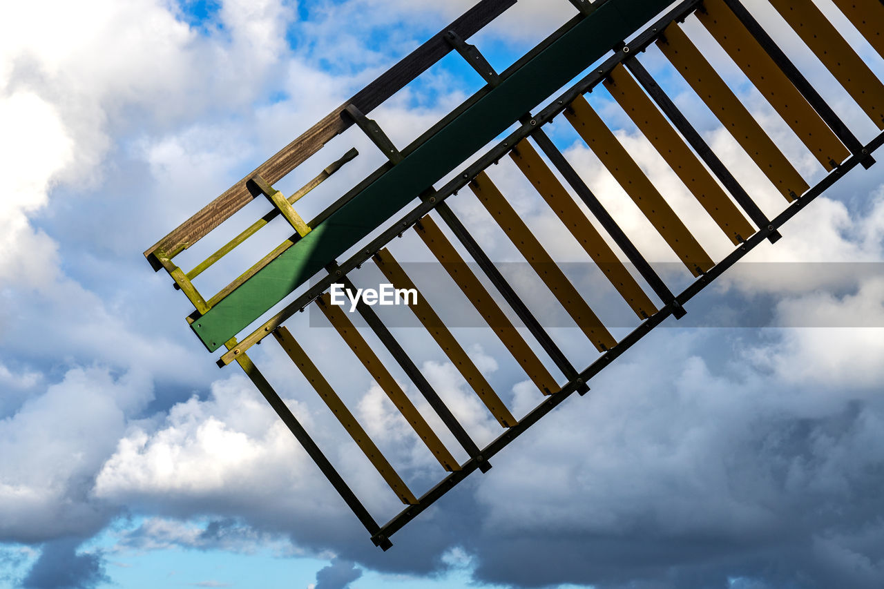 LOW ANGLE VIEW OF METAL STRUCTURE AGAINST BLUE SKY