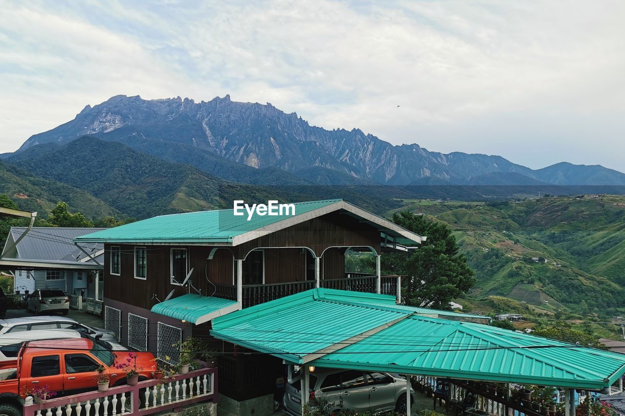 BUILT STRUCTURE BY BUILDINGS AGAINST MOUNTAINS