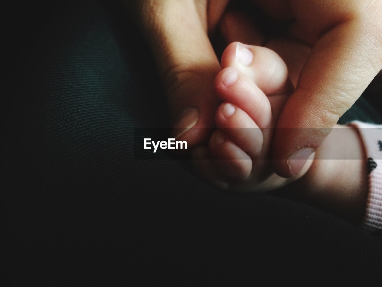 Close-up of hand holding the foot of a baby