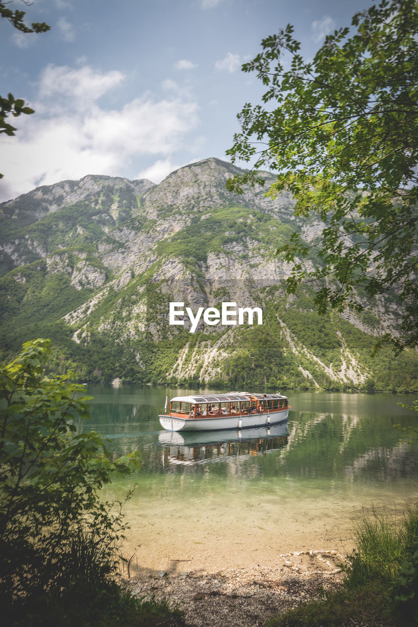 Boat in lake against sky