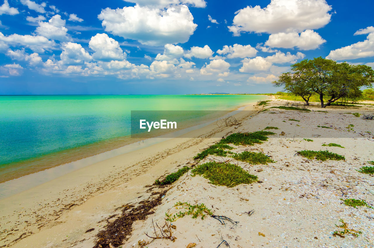 Scenic view of caribbean sea against cloudy sky