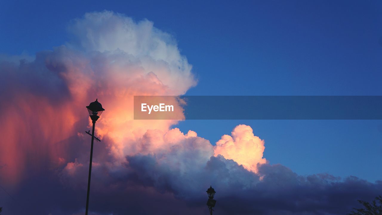 Low angle view of street light against cloudy sky during sunset