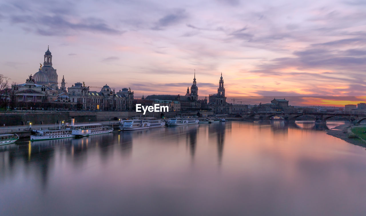 View of city at waterfront during sunset