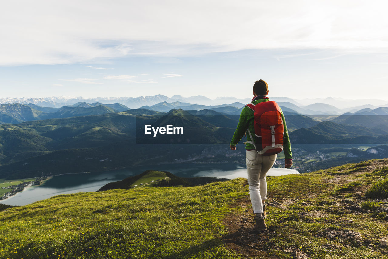 Austria, salzkammergut, hiker with backpack hiking in the alps