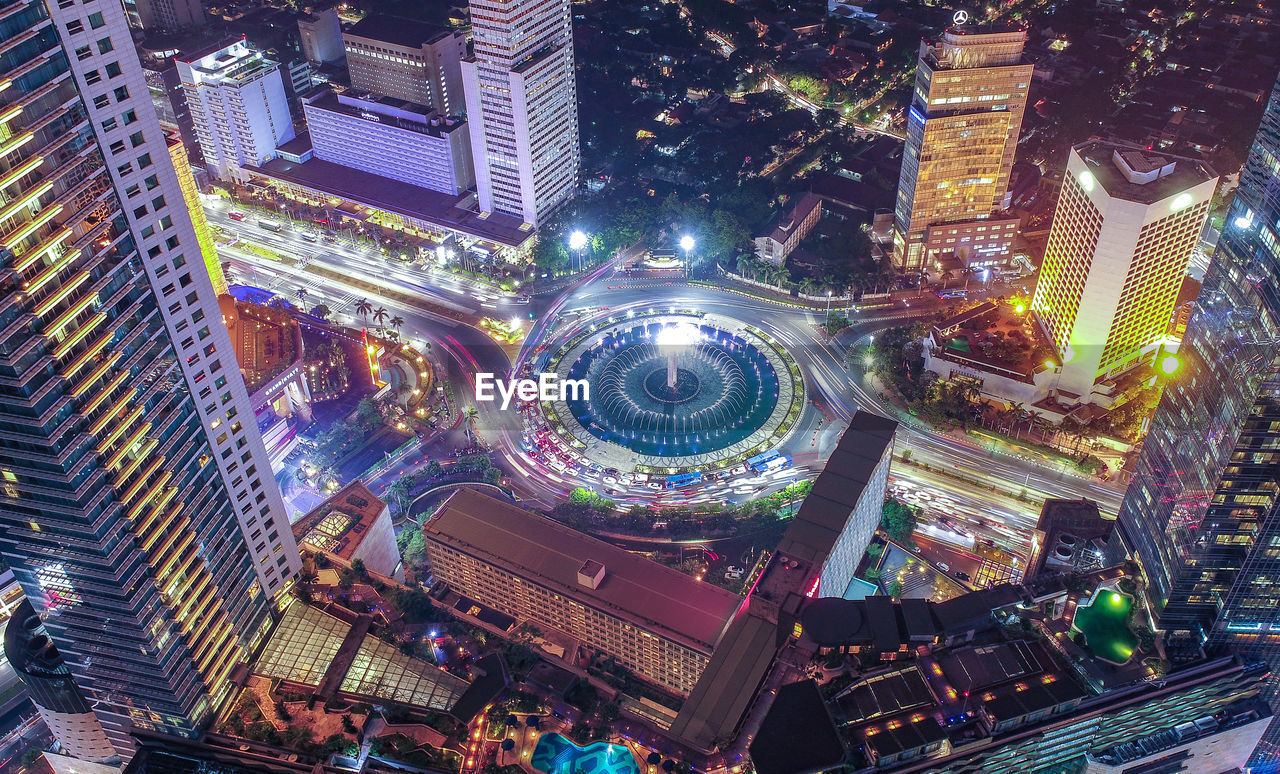 High angle view of illuminated buildings in city at night