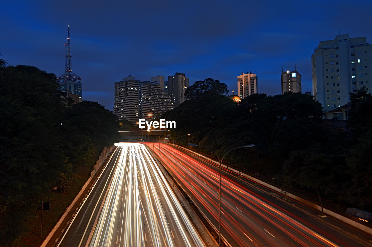 Light trails on road in city at night