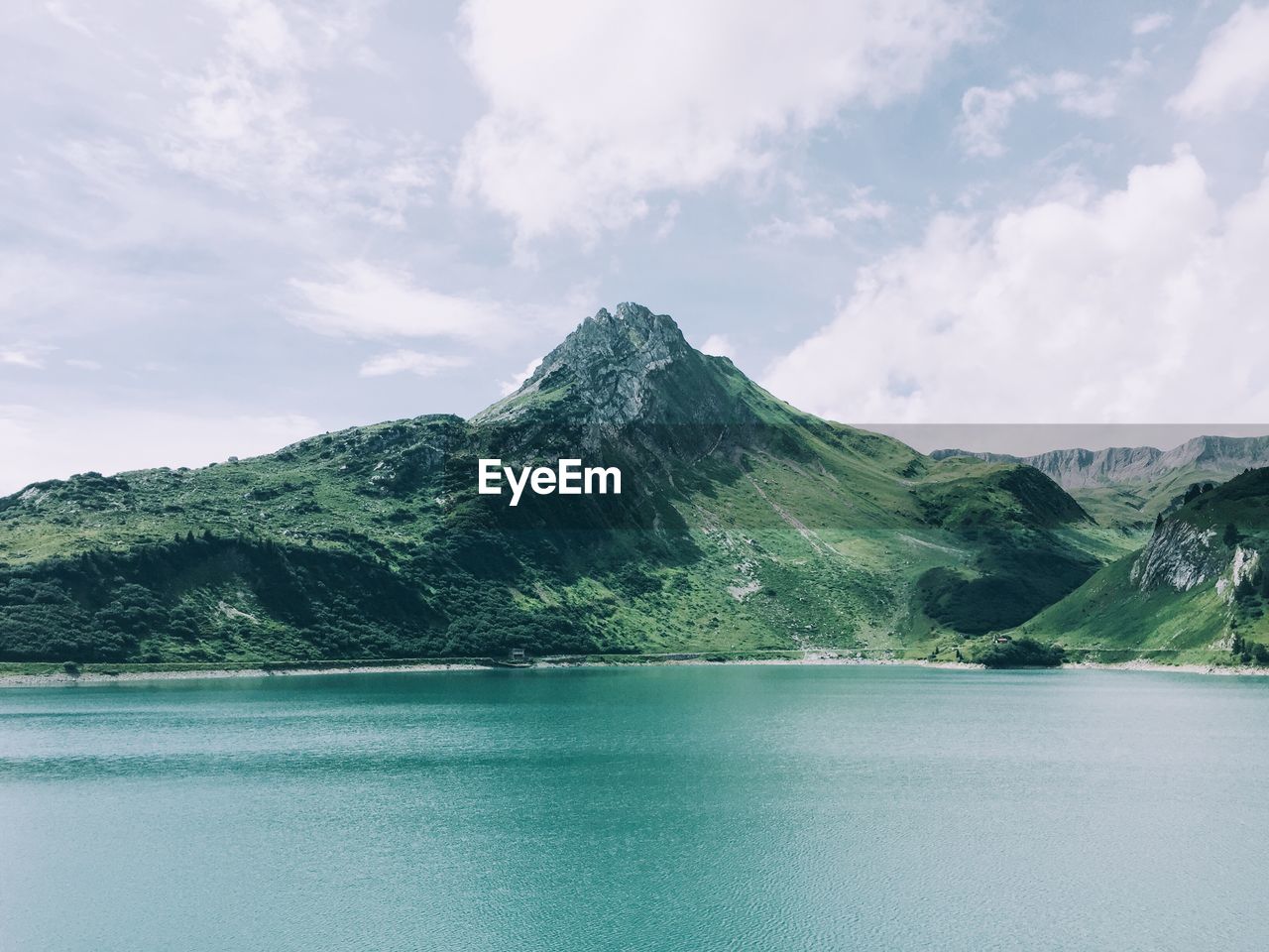 Scenic view of lake and mountains against sky