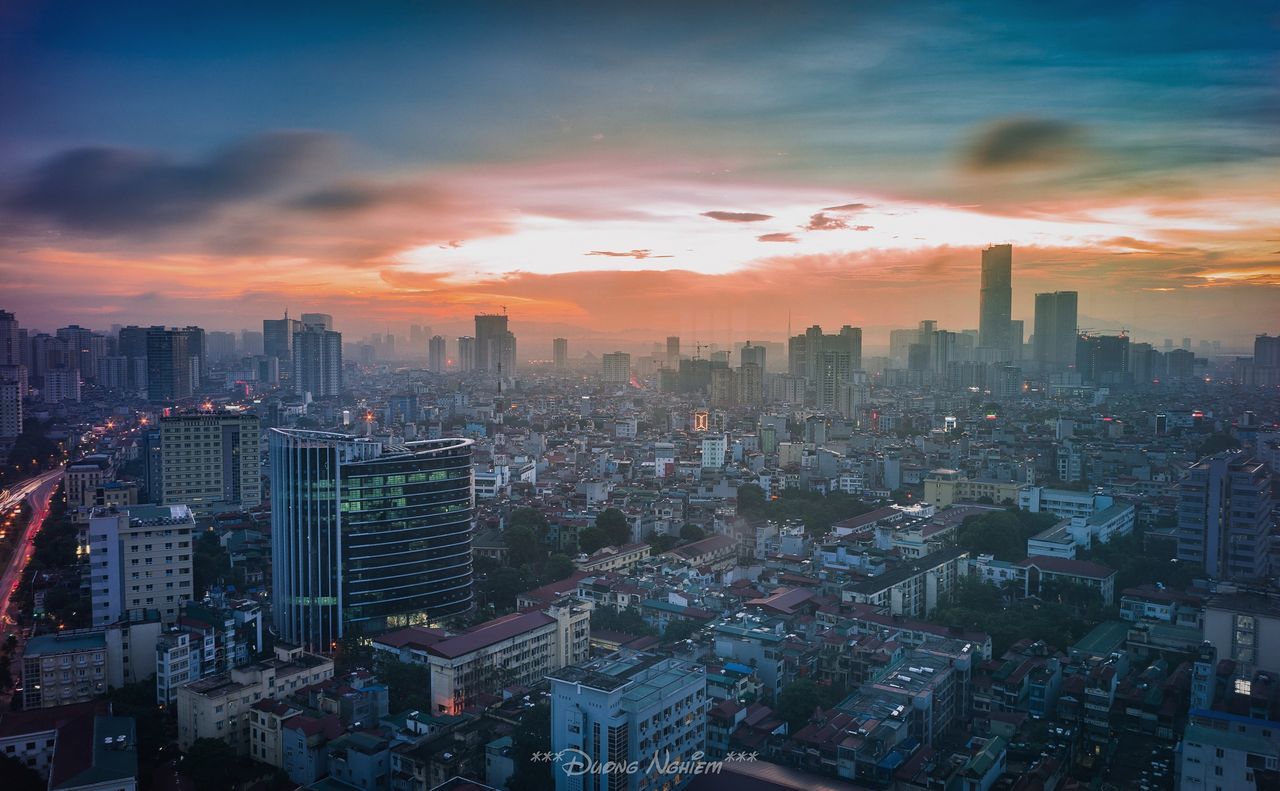 Aerial view of cityscape against sky during sunset