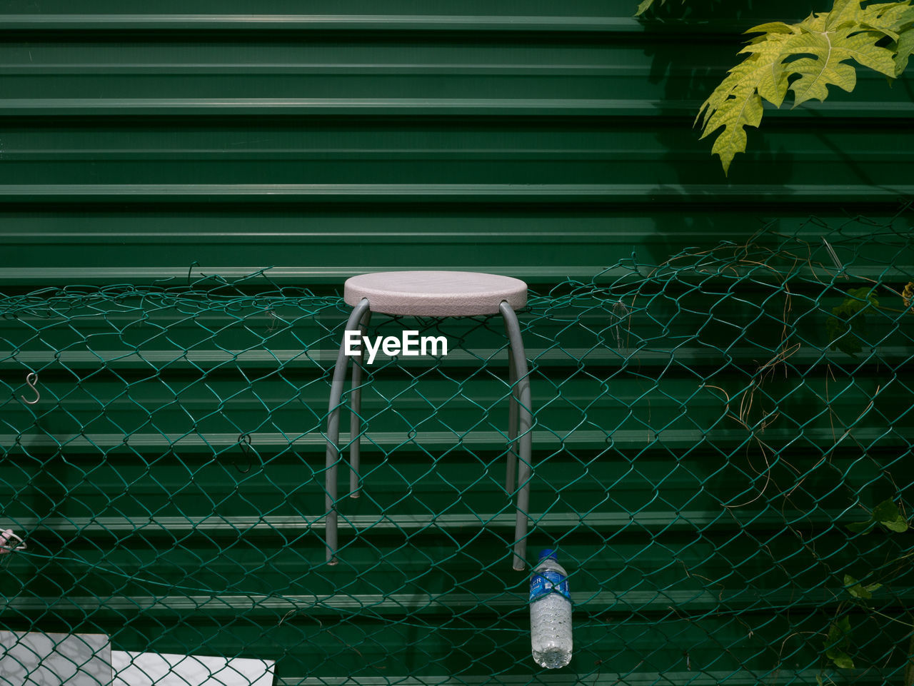 Close-up of table on chainlink fence