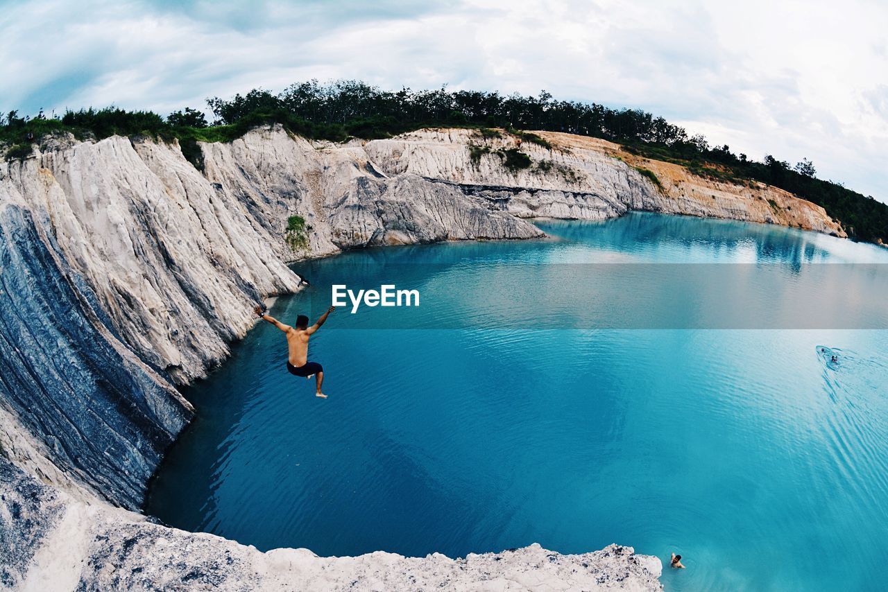 Scenic view of person jumping into water