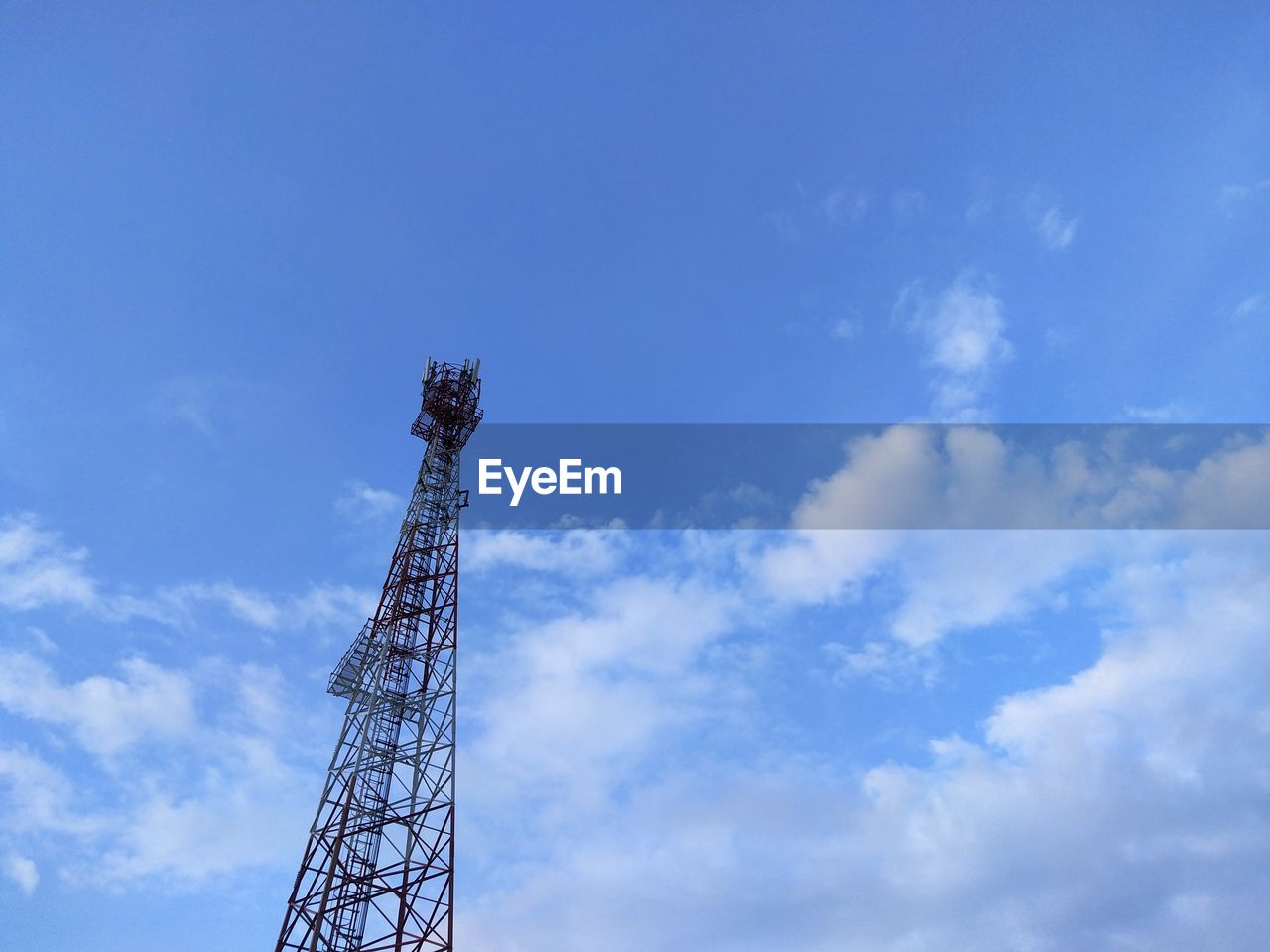 Low angle view of communications tower against sky