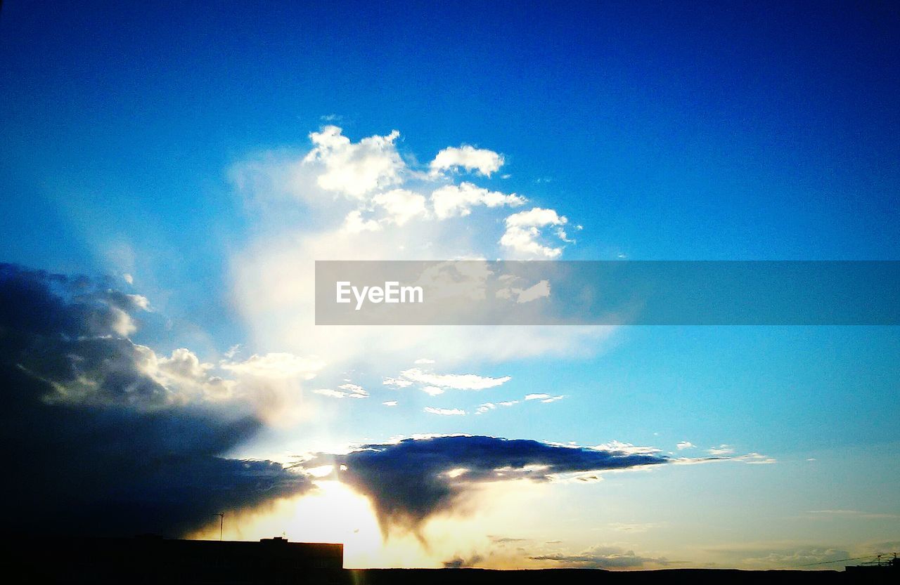 LOW ANGLE VIEW OF SILHOUETTE BLUE SKY AND CLOUDS