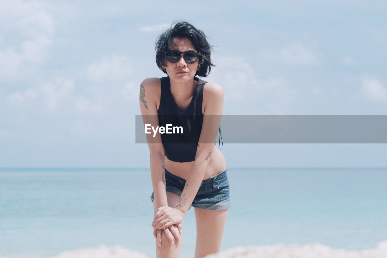 Young woman standing at beach