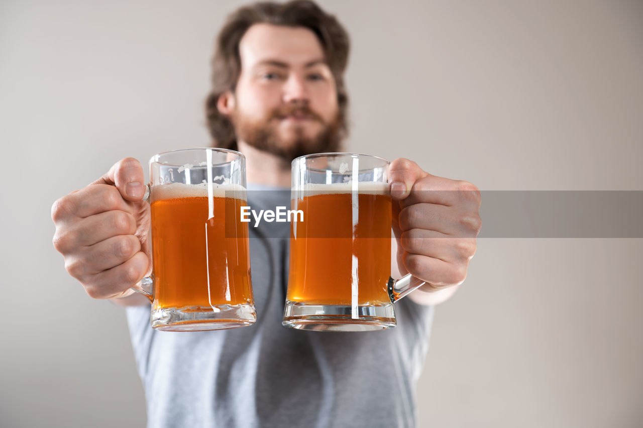 CLOSE-UP OF A MAN DRINKING GLASS ON WHITE