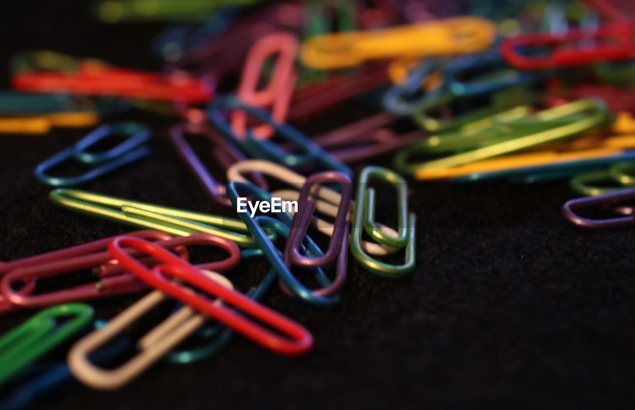 Close-up of colorful paper clips on table