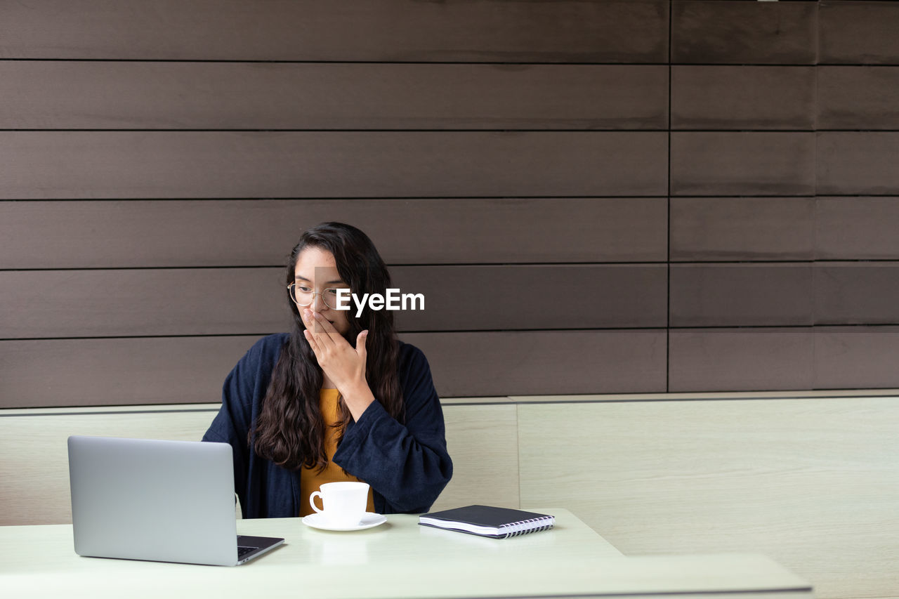 Shocked female freelancer using netbook