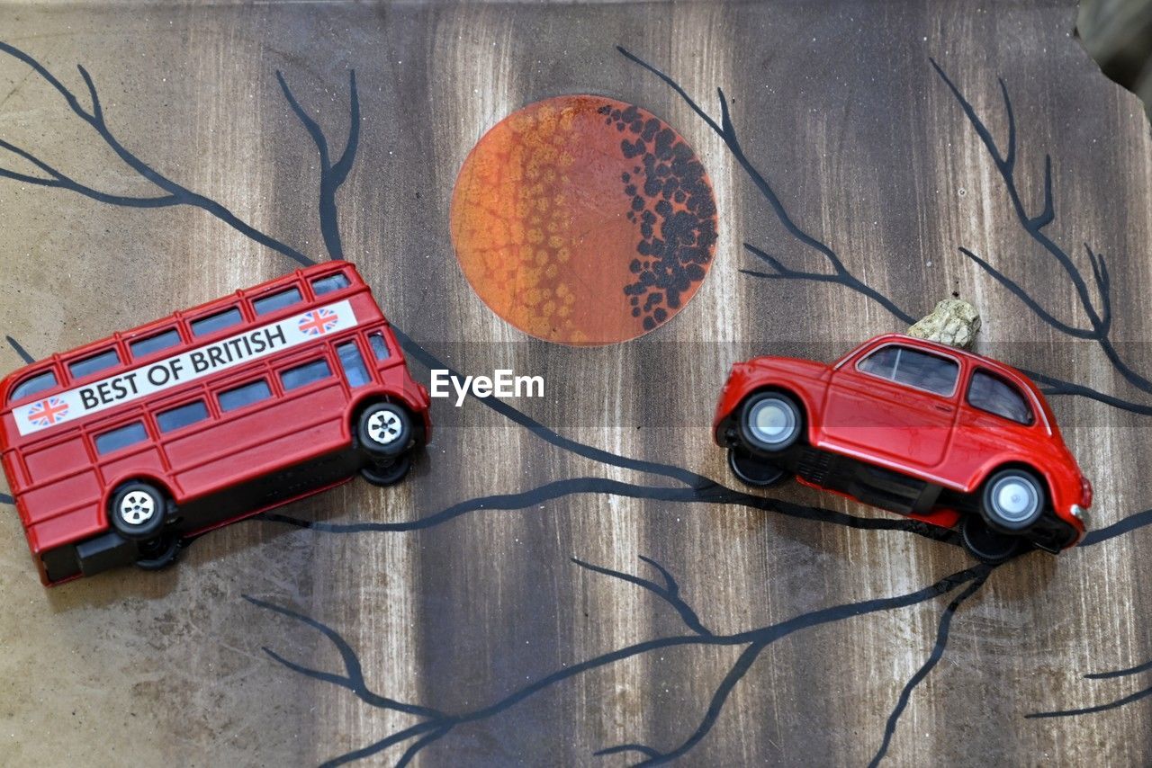 red, toy, vehicle, car, no people, high angle view, motor vehicle, toy car, technology, mode of transportation, transportation, still life, indoors