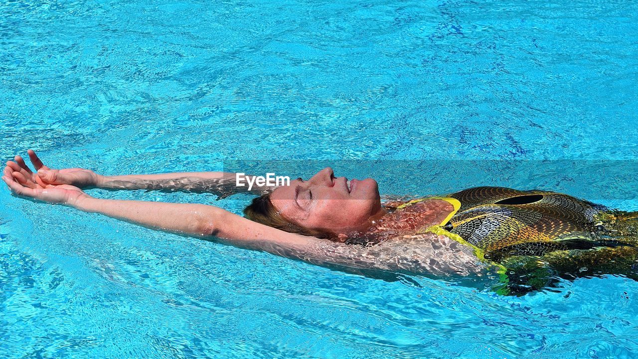 High angle view of swimmer in swimsuit swimming in pool