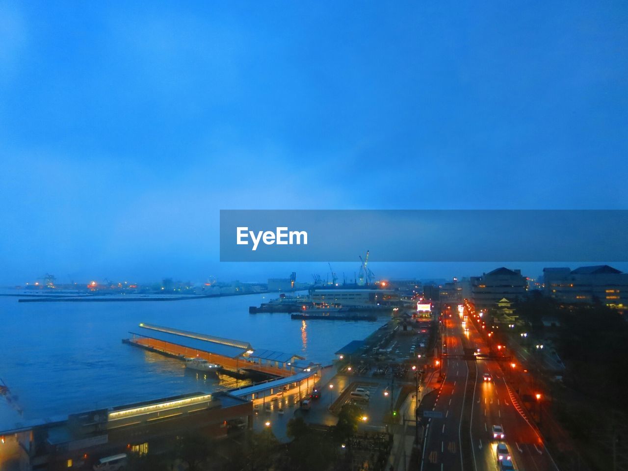 High angle view of road along calm blue sea