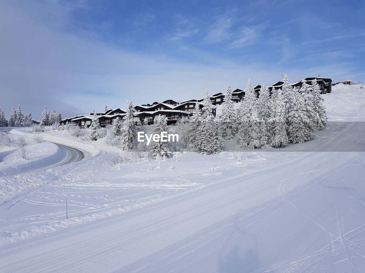 Snow covered land against sky