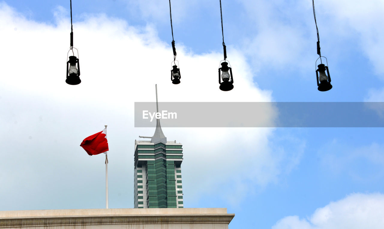 LOW ANGLE VIEW OF FLAGS HANGING AGAINST SKY