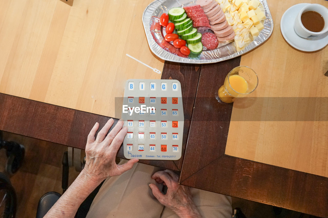 MIDSECTION OF MAN HOLDING BREAKFAST AT HOME