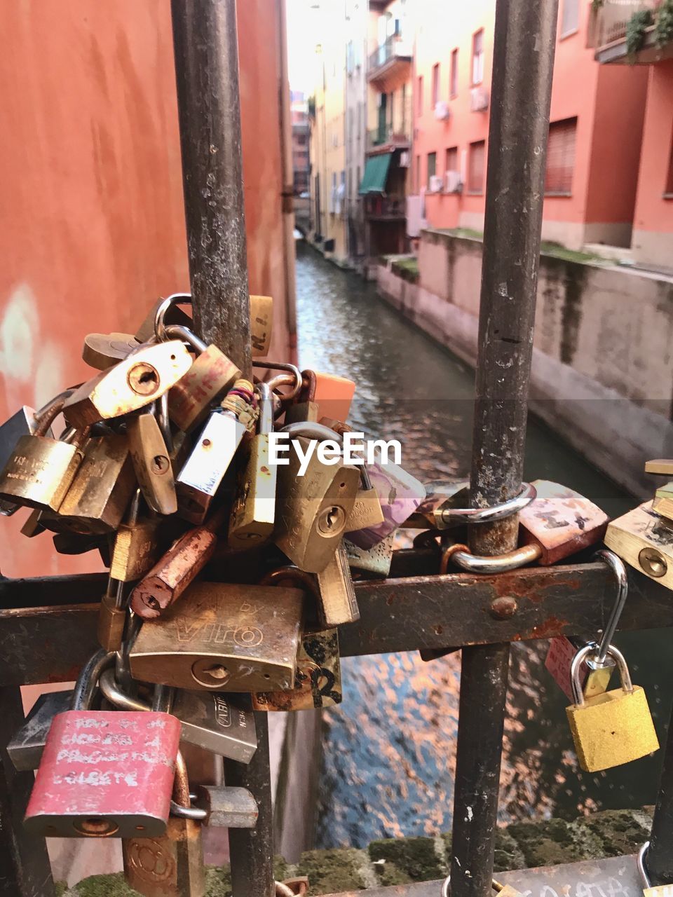 CLOSE-UP OF PADLOCKS ON METAL RAILING