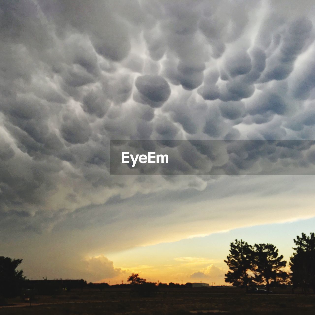 Scenic view of dramatic sky over silhouette landscape