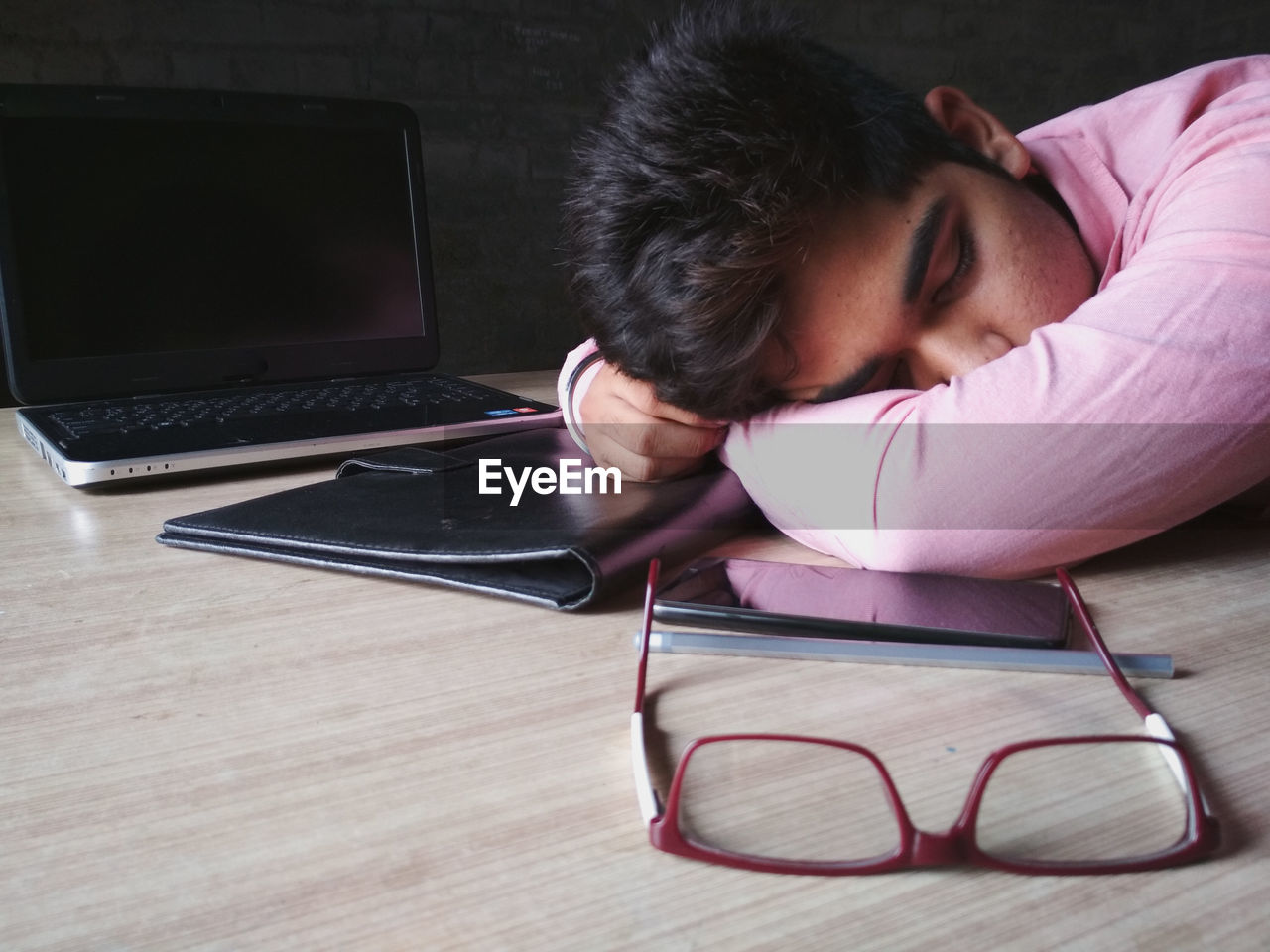 Boy with objects sleeping at table