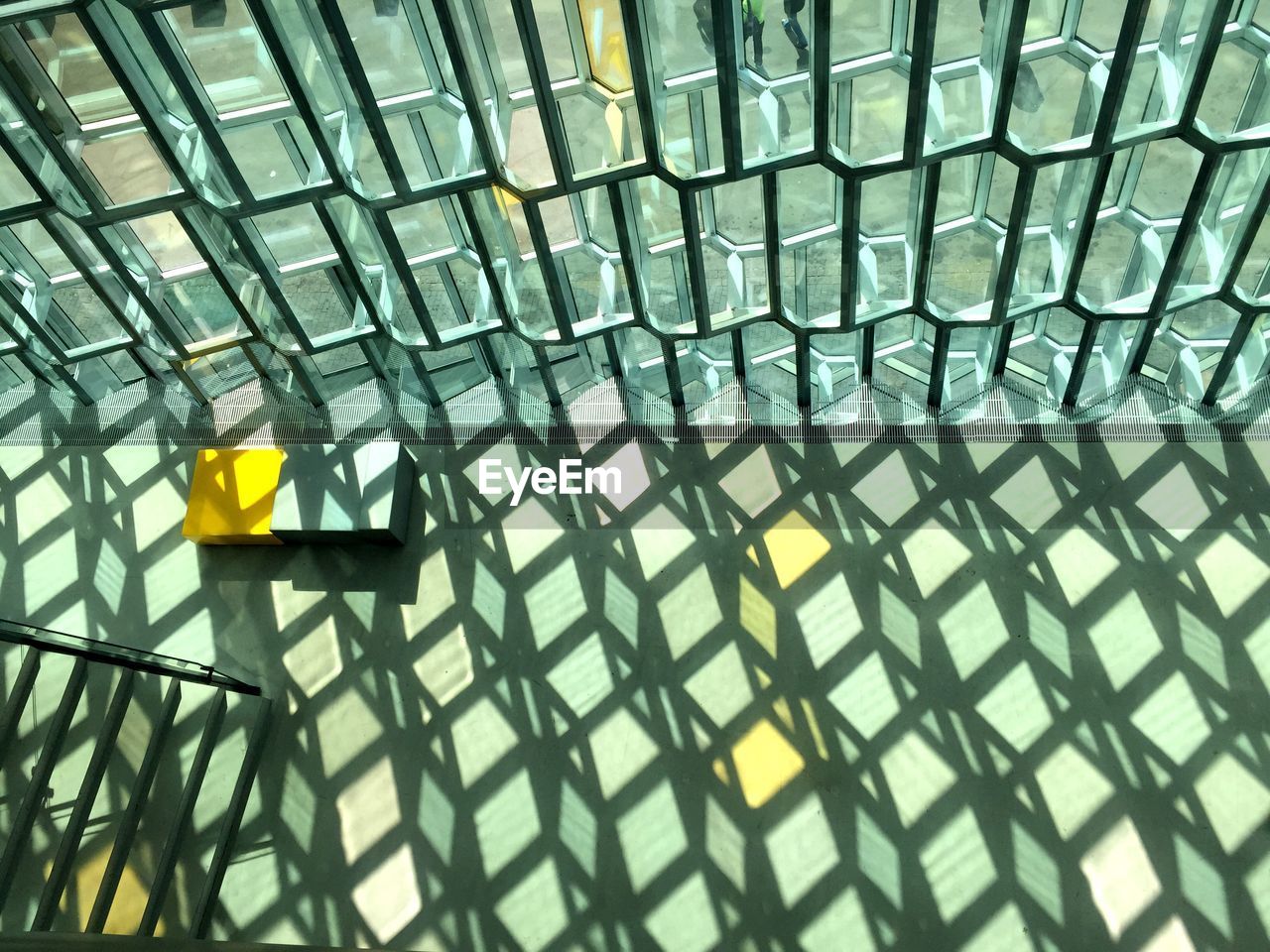 High angle view of shadow of glass window on floor at lobby