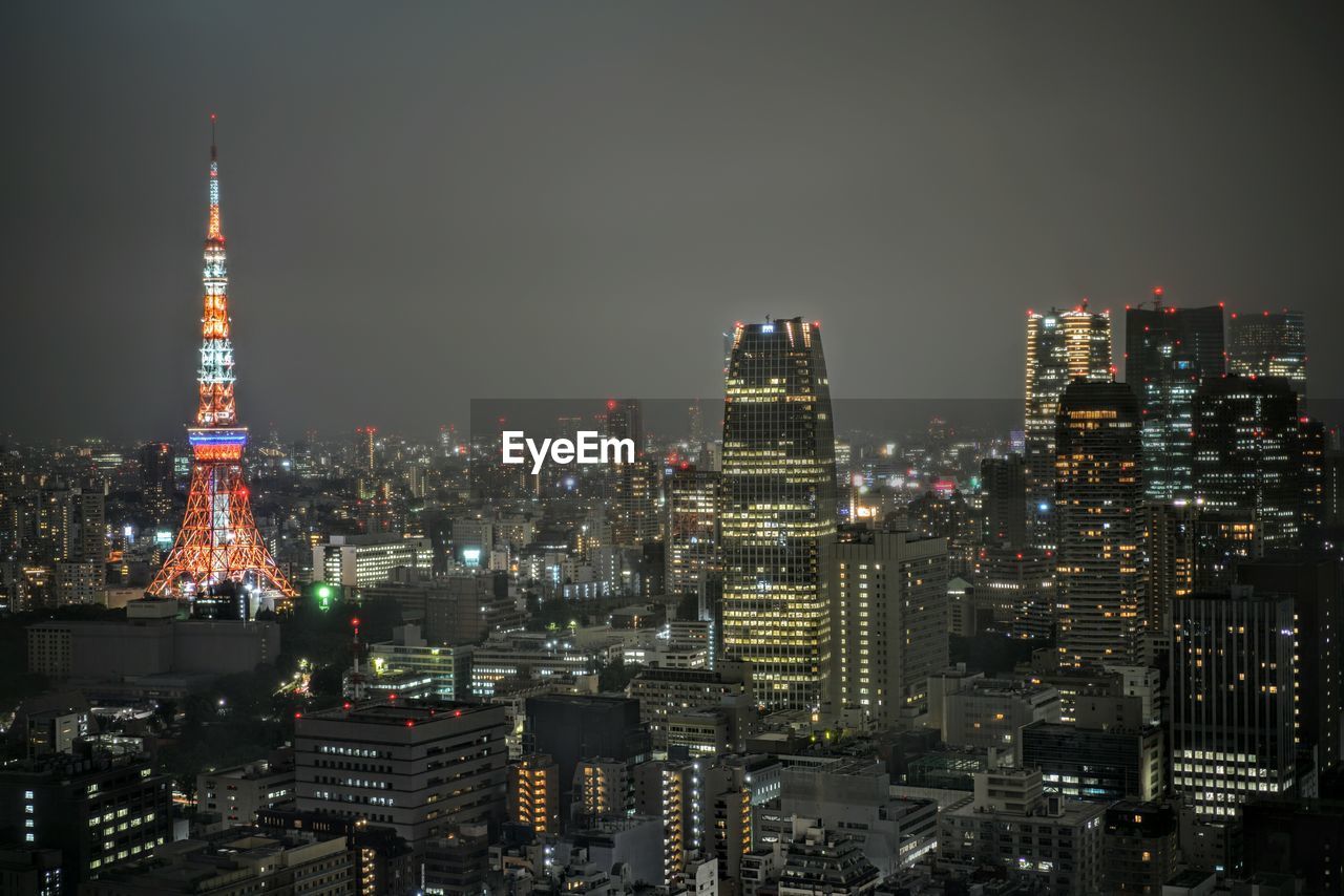 Illuminated cityscape against sky at night