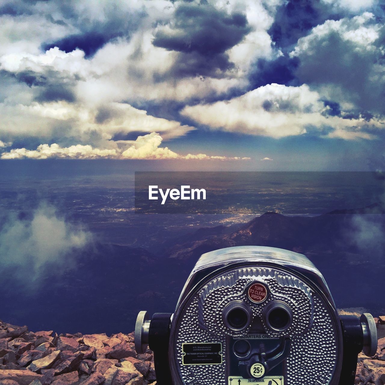 CLOSE-UP OF COIN-OPERATED BINOCULARS ON CITYSCAPE