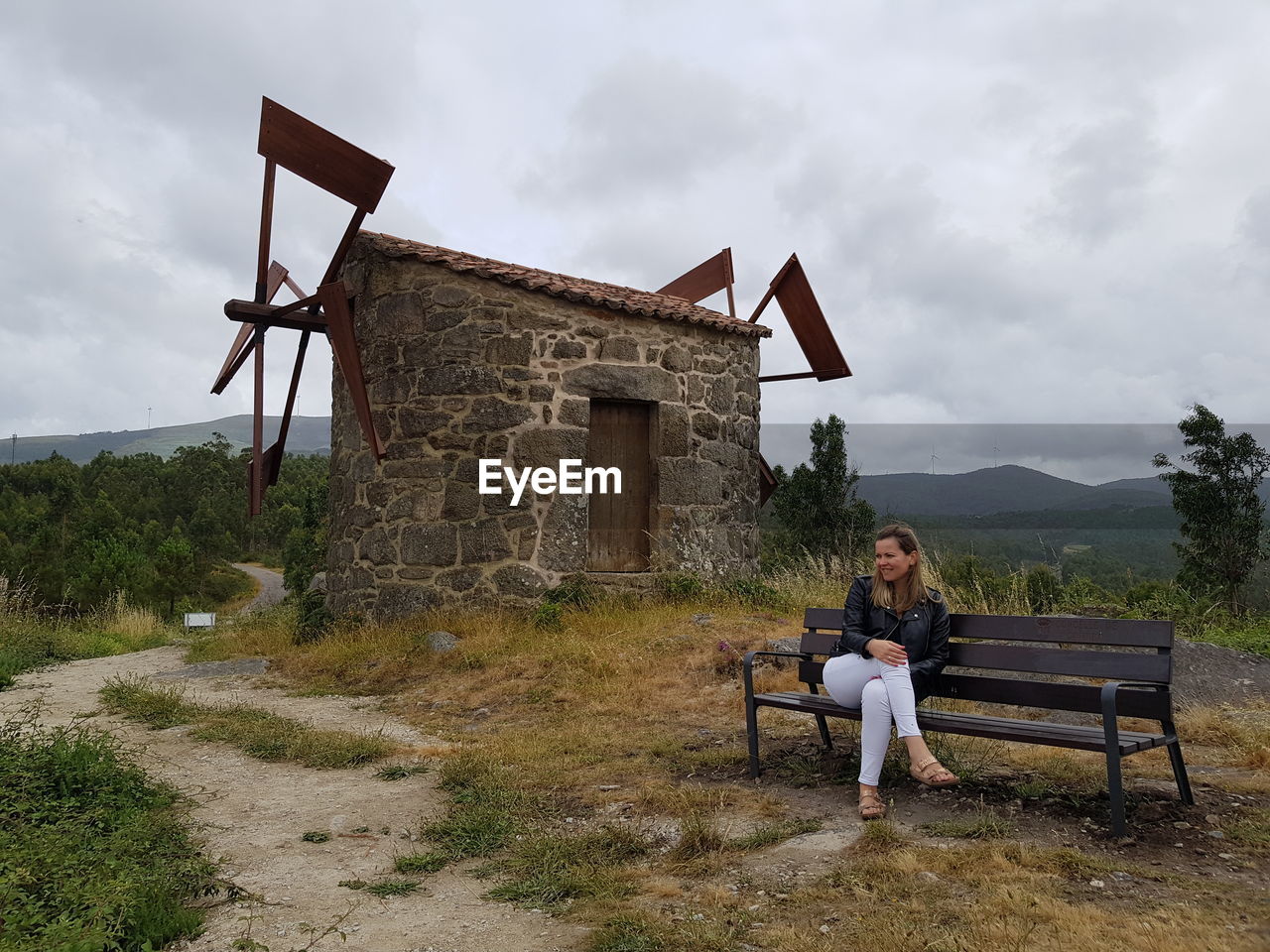 WOMAN SITTING ON BENCH