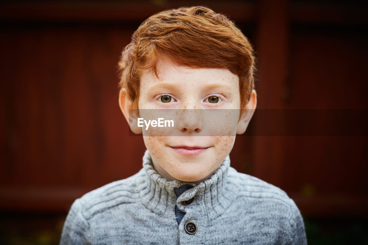 Portrait of smiling boy in yard